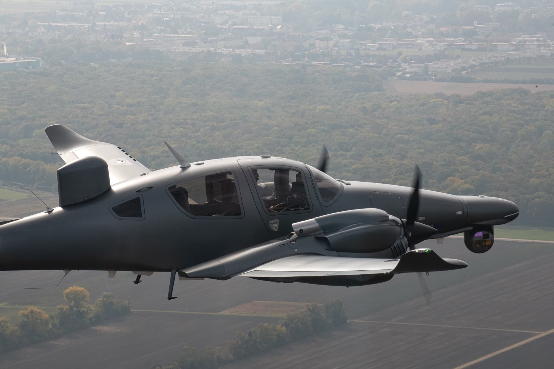 Diamond DA62 MPP in flight showing its mission sensor turret and belly radar