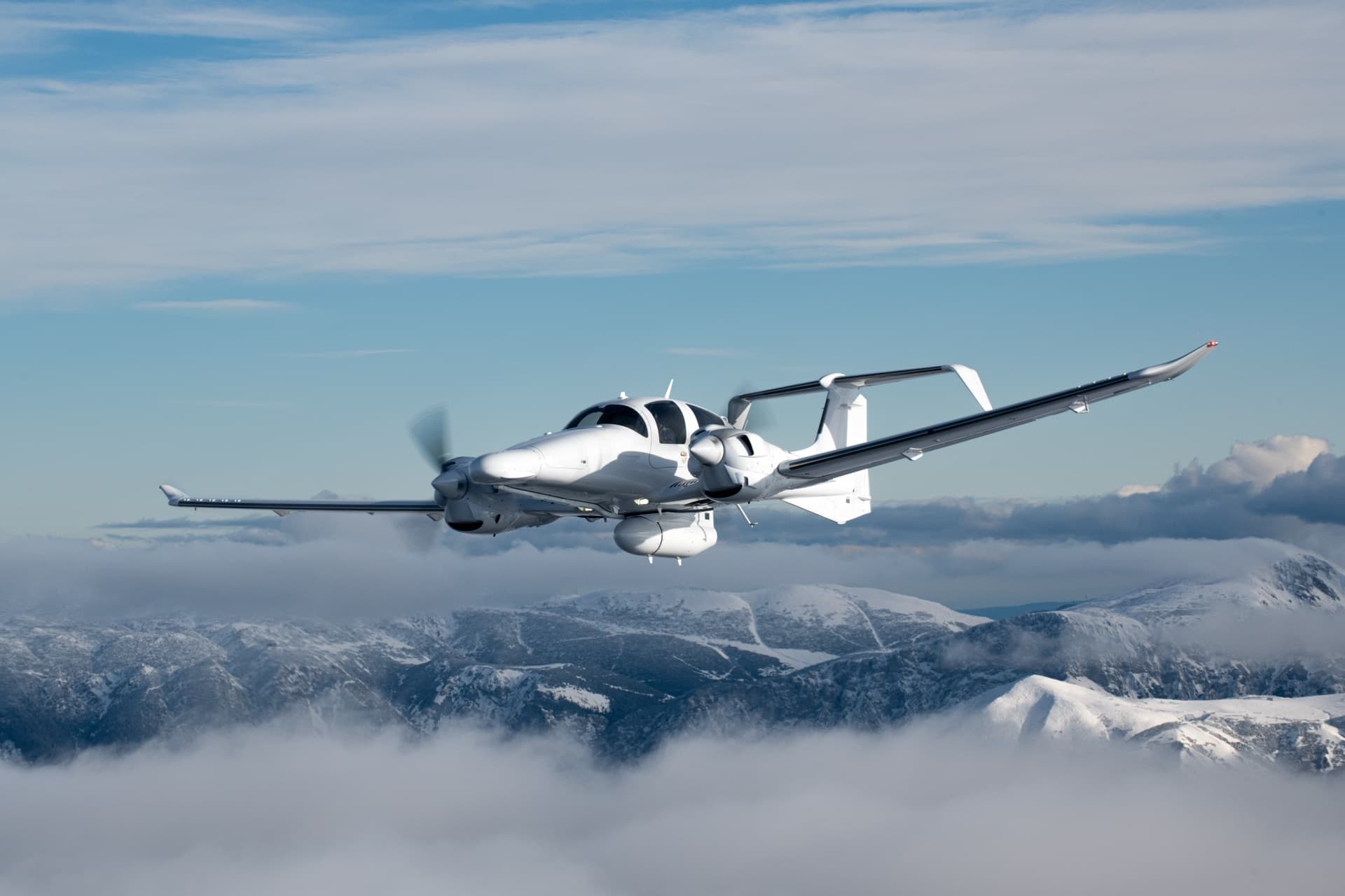 Diamond DA62 MPP special mission aircraft in flight over snow-capped mountains